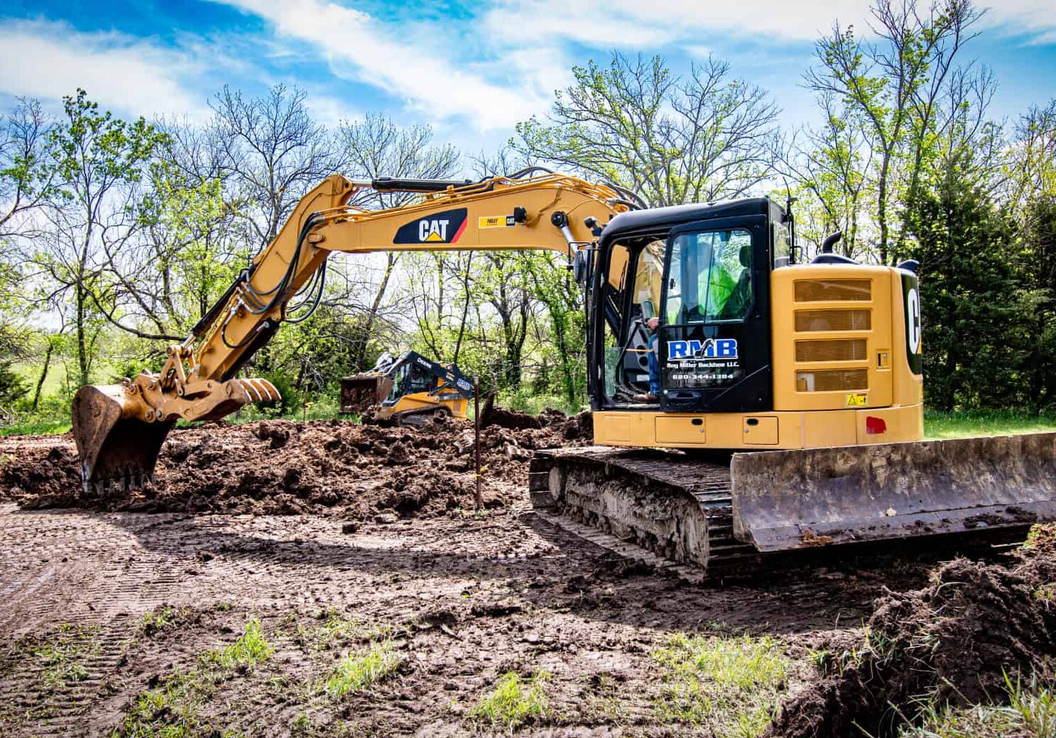 Excavation contractor using track hoe equipment to clear land.